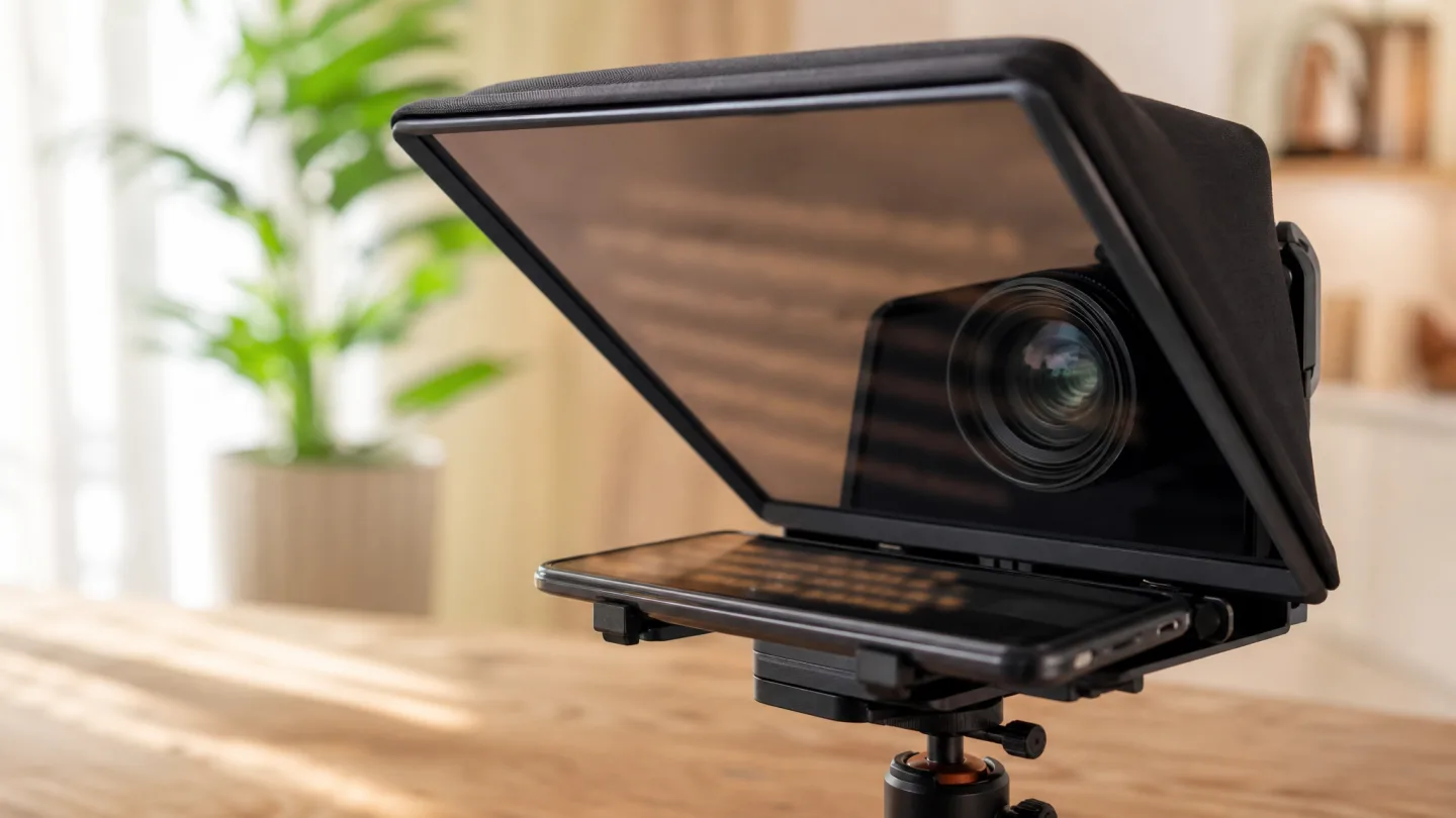 A close view of a beam-splitter teleprompter with a camera lens behind the angled glass